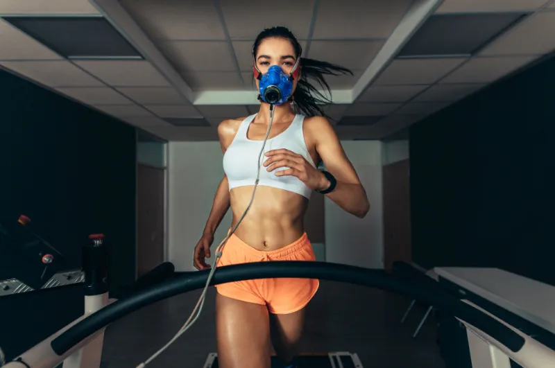 Girl running on treadmill doing vo2 max test