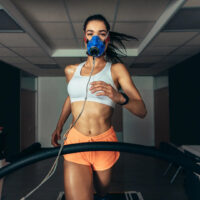 Girl Running on treadmill hooked up to VO2 machine